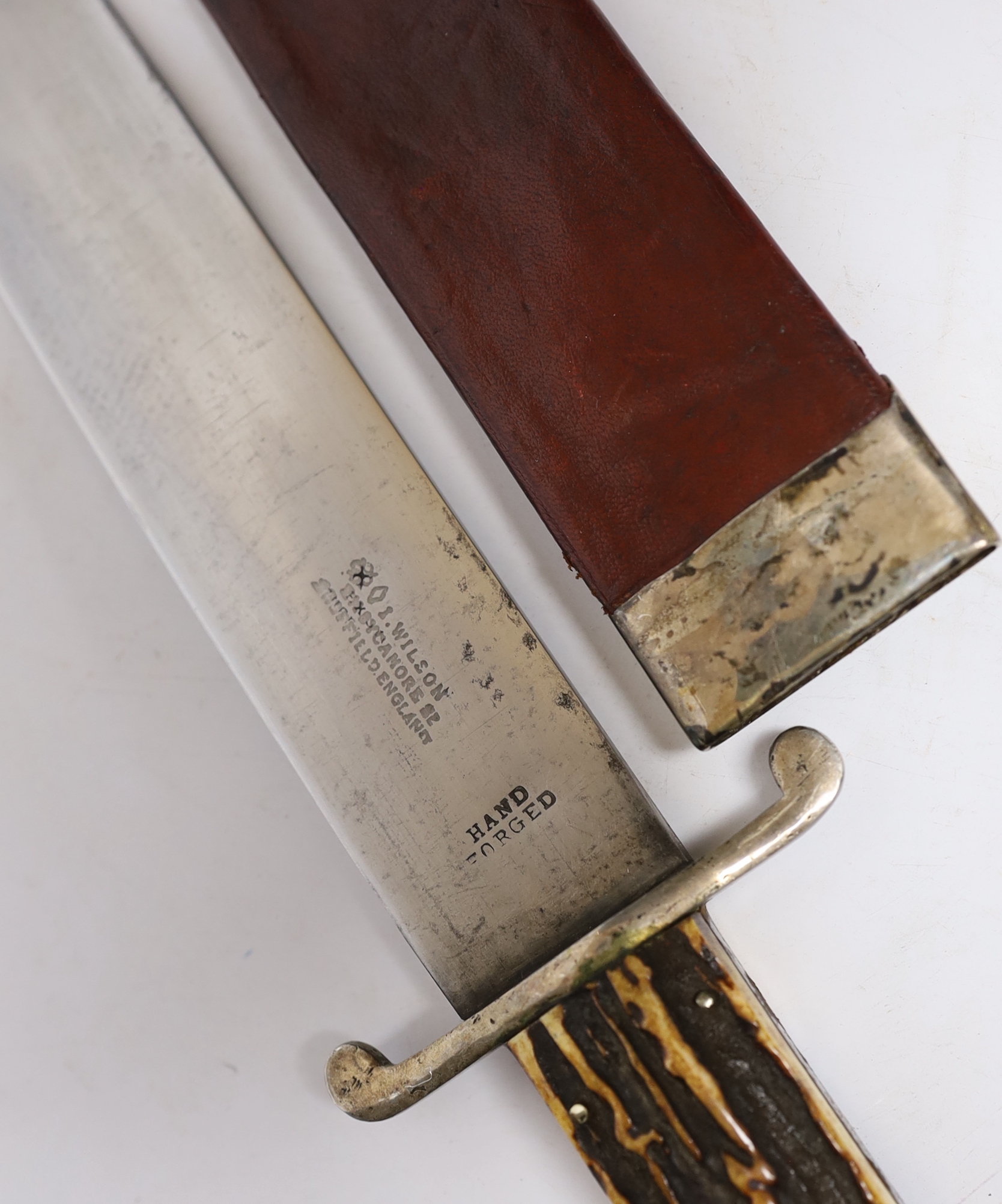 A John Wilson 19th century Bowie knife, spearpoint blade, stamped hand, forged, J, Wilson Sycamore Street, Sheffield, with peppercorn and diamond trade marks, horn, grip, and red leather scabbard with rose pattern stud,